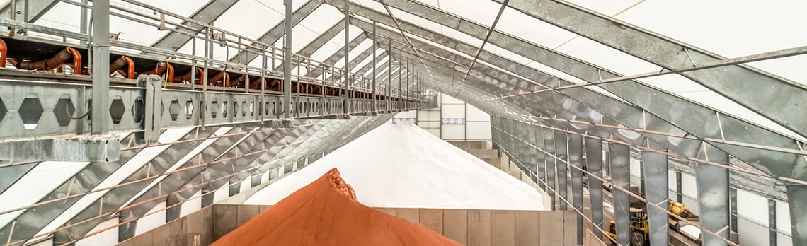 tension fabric building with conveyor and fertilizer stored inside bins