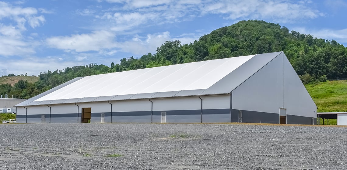 white and gray livestock handling facility clad with PVC