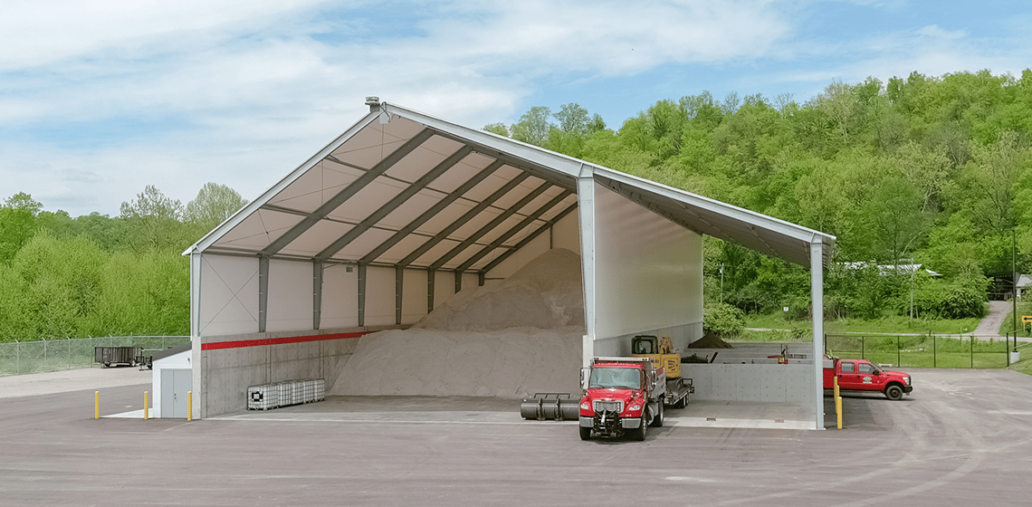 salt storage facility with open endwall and lean-to for equipment