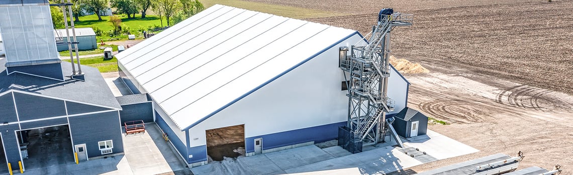 tension fabric fertilizer storage building wit conveyor and connected to additional structure