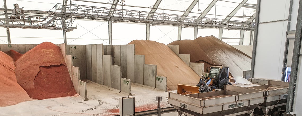 Storage bins in a fabric fertilizer storage facility