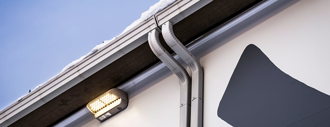 eave of tension fabric building with gutters and icebreakers
