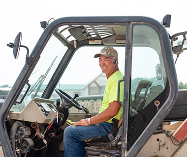 worker on forklift in high-vis shirt