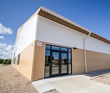 fabric building eave with gutters and downspouts