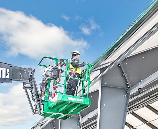 installer working on a tension fabric building