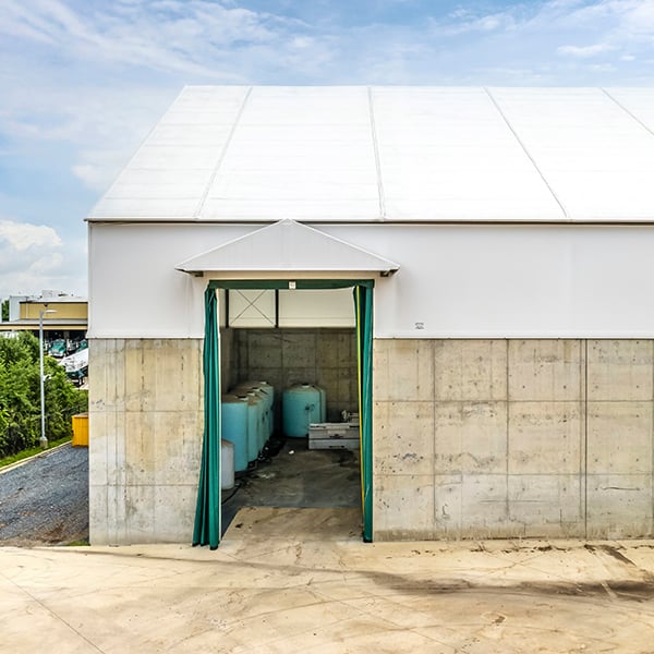 tension fabric building door protected by a dormer 