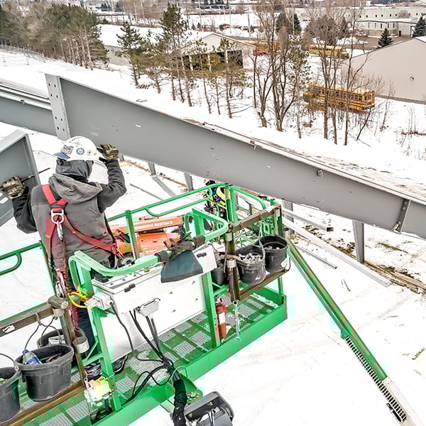 installing roof beams on a tension fabric building