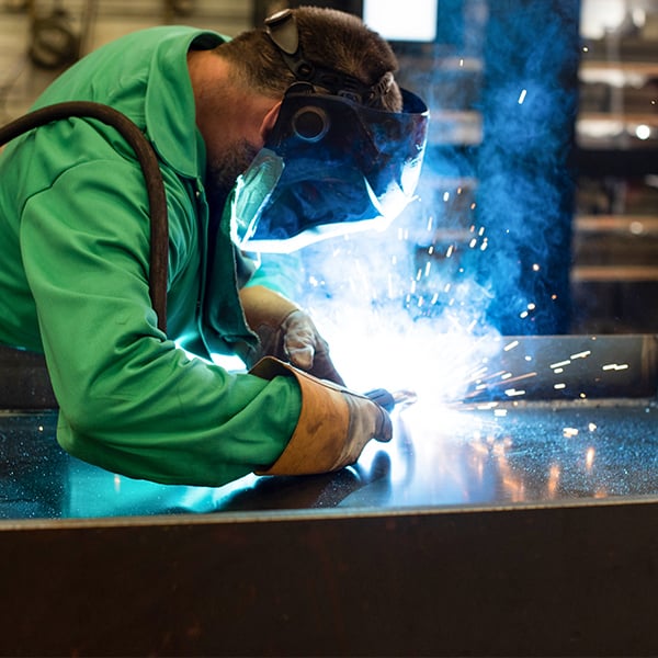 welder welding a steel beam