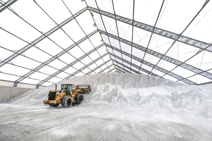 forklift inside large tension fabric salt storage building